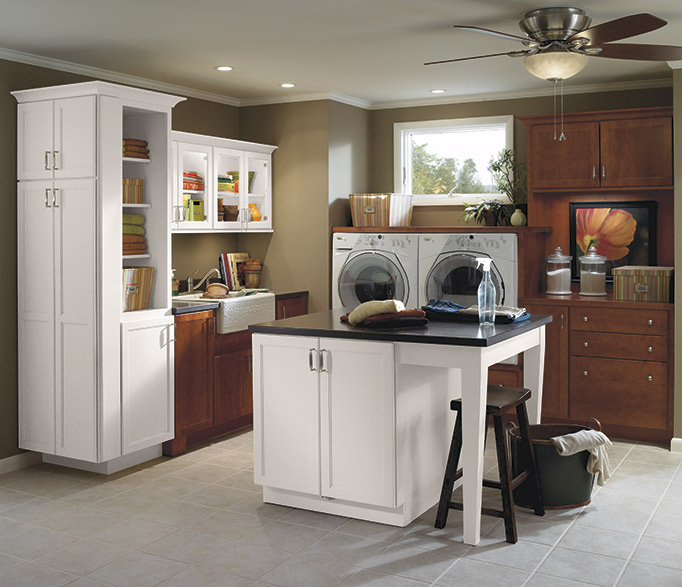Casual laundry room cabinets in dark maple stain and white paint