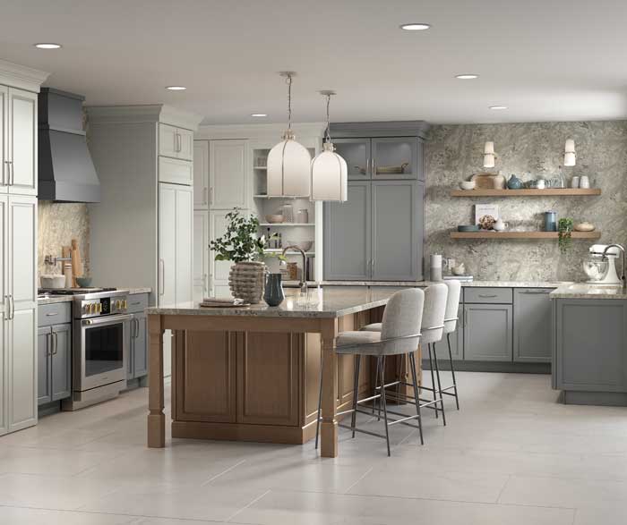 kitchen featuring multiple finishes with white and medium gray wall and base cabinets and stained brown island