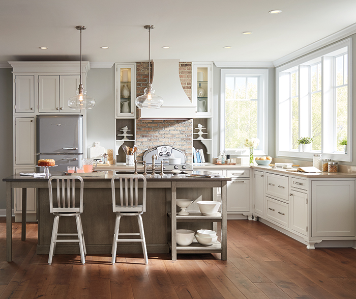kitchen with white cabinets and light stained island featuring wood hood, glass front cabinets and open shelves